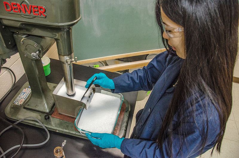 Qingqing Huang, assistant professor of mining engineering at West Virginia University, conducts a froth flotation test to separate carbonaceous materials from coal waste.